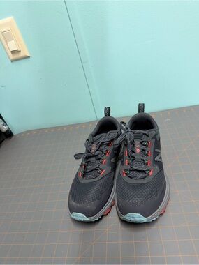 New Balance Men's Black Athletic Shoes with Red Accents